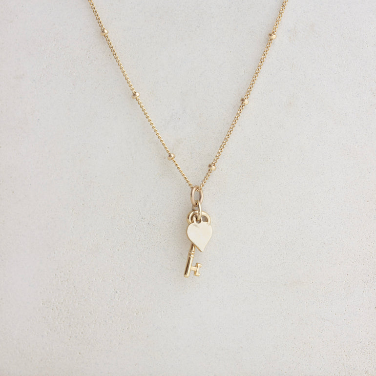 dainty key and heart charm on gold chain