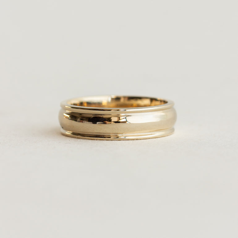 wide cigar wedding band with detailing