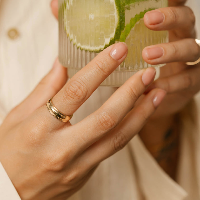 wide cigar wedding band on models hand