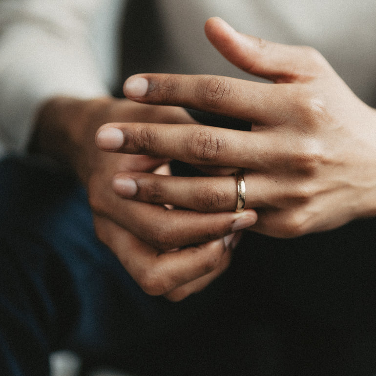 mens hands with european wedding band on