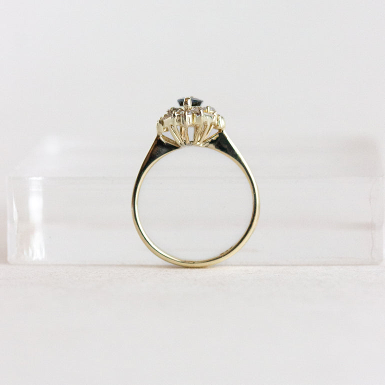Gold ring with a diamond on a white background