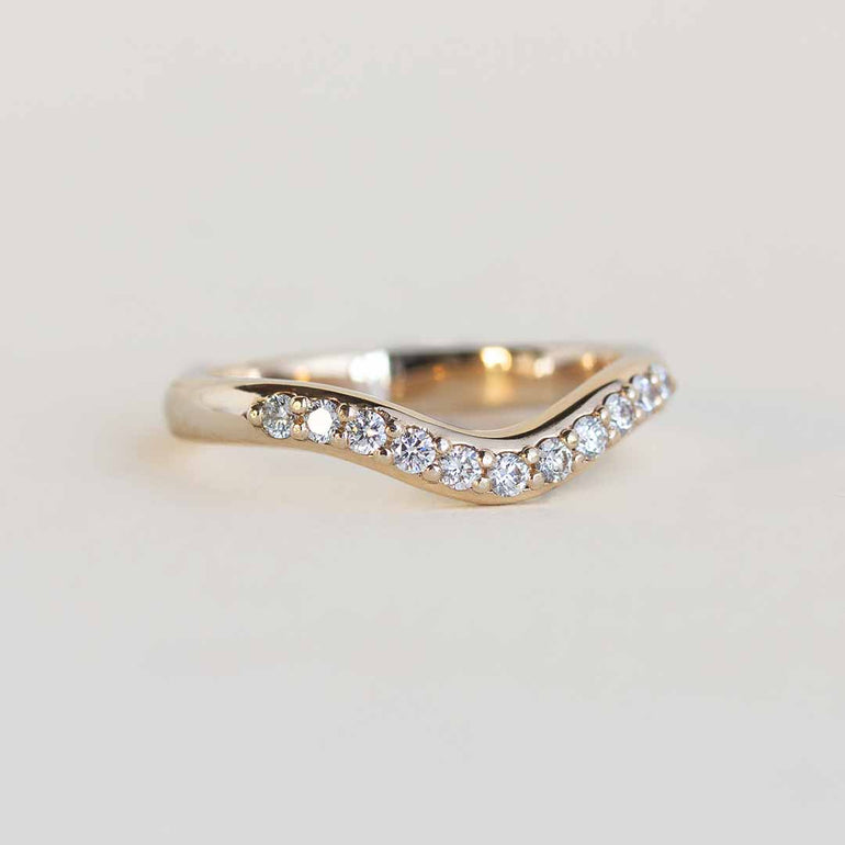 Yellow gold contour band with 11 channel set diamonds