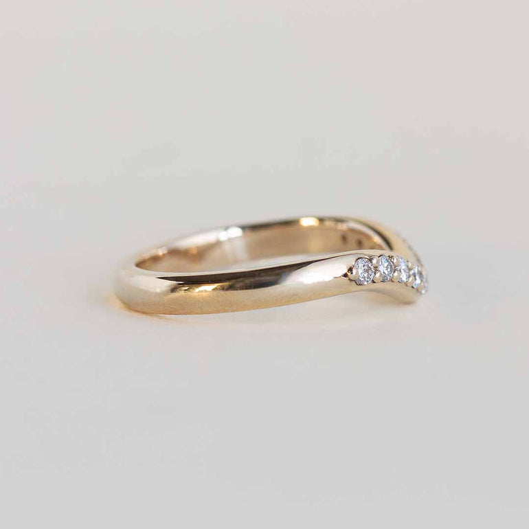 Yellow gold contour band with 11 channel set diamonds