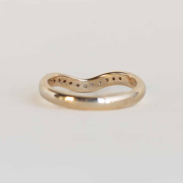 Yellow gold contour band with 11 channel set diamonds