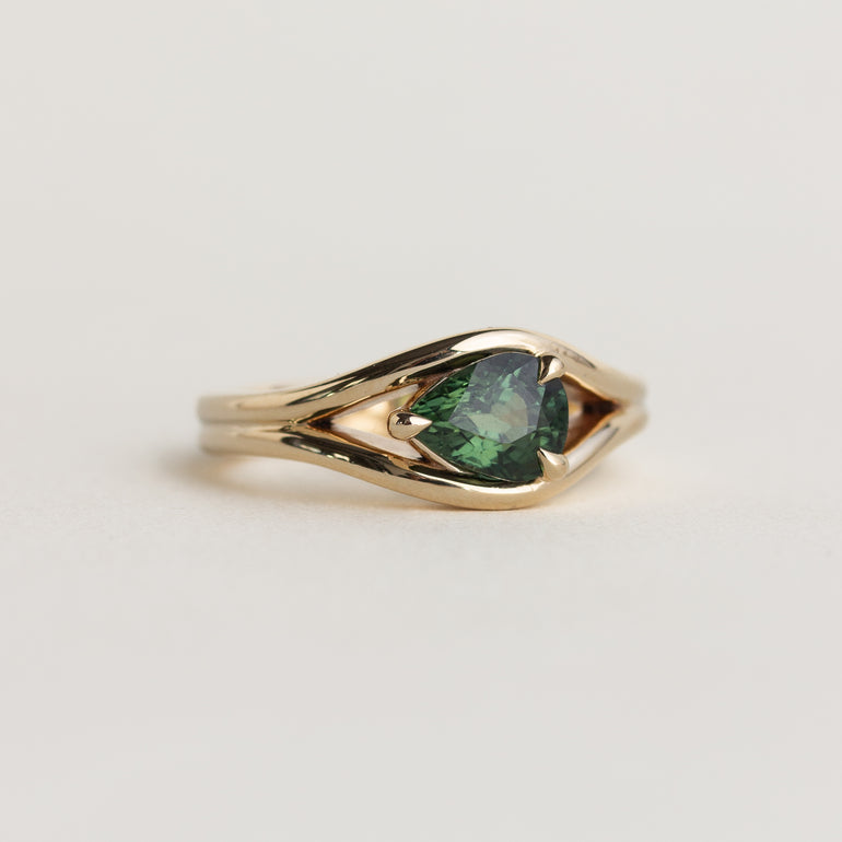 14K gold Lola ring with an east-west pear shaped, medium-green sapphire