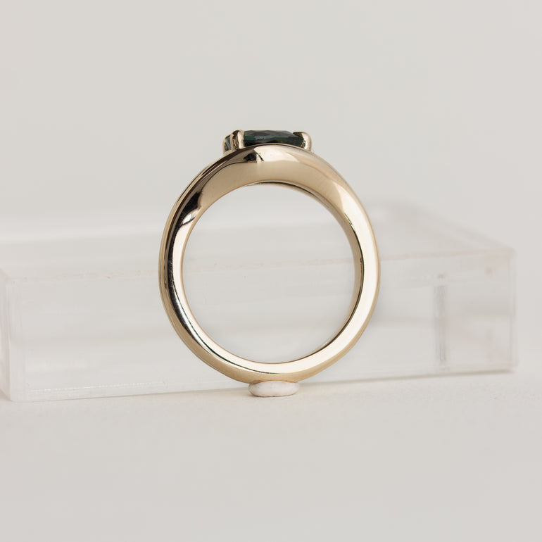 14K gold Lola ring with an east-west pear shaped, medium-green sapphire