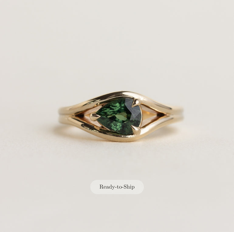 14K gold Lola ring with an east-west pear shaped, medium-green sapphire