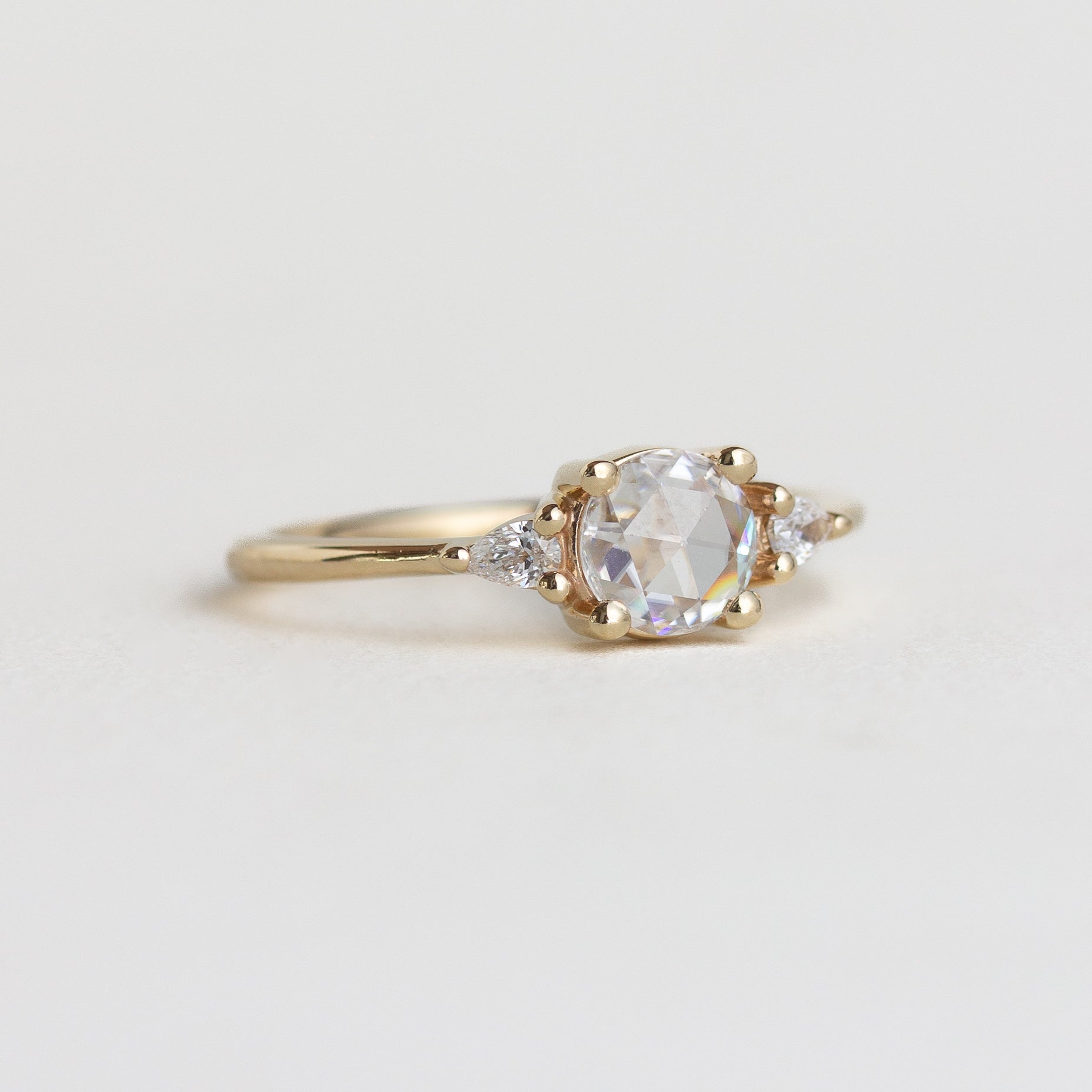 14K gold ring with moissanite centre stone and two natural diamonds