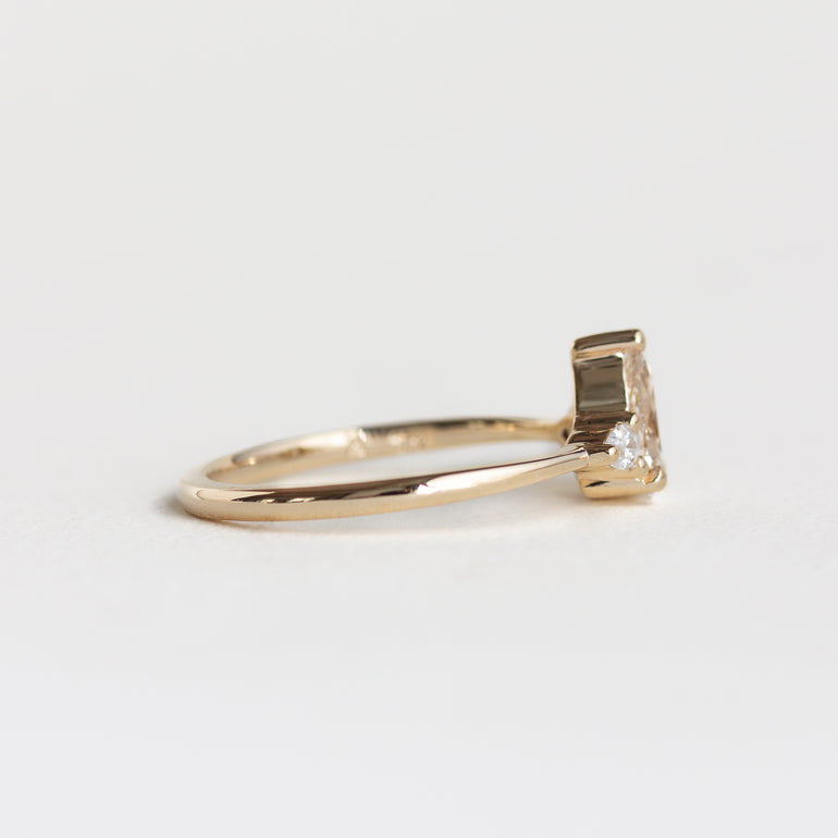 14k gold pear, three stone Marie ring with a champagne diamond