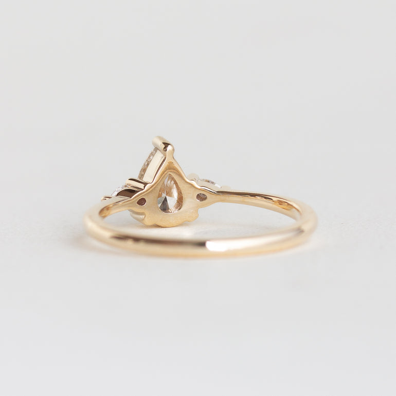 14k gold pear, three stone Marie ring with a champagne diamond