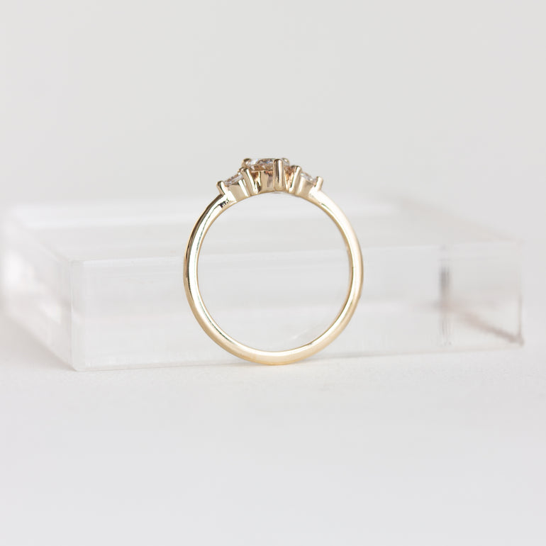 14k gold pear, three stone Marie ring with a champagne diamond