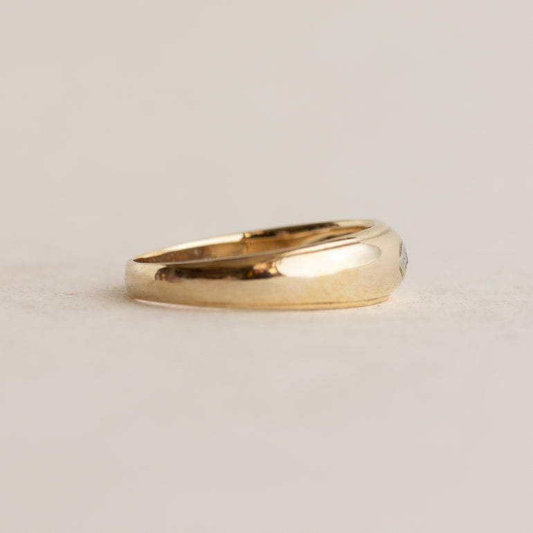 Gold ring on a light beige background