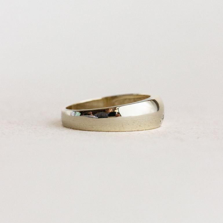 Gold ring on a light gray background