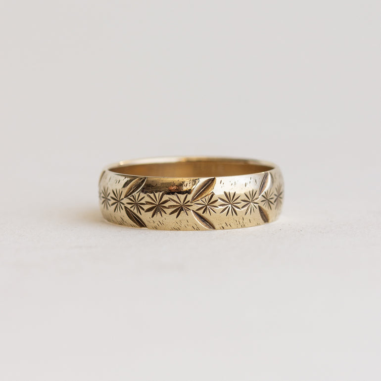 Silver ring with a diamond on a light gray background