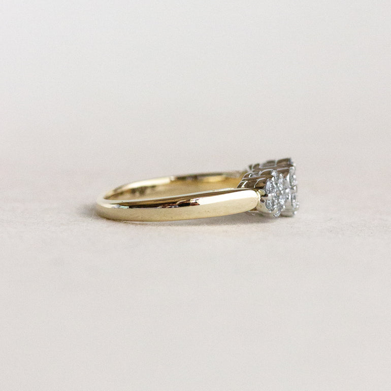 Gold ring with a diamond on a light gray background