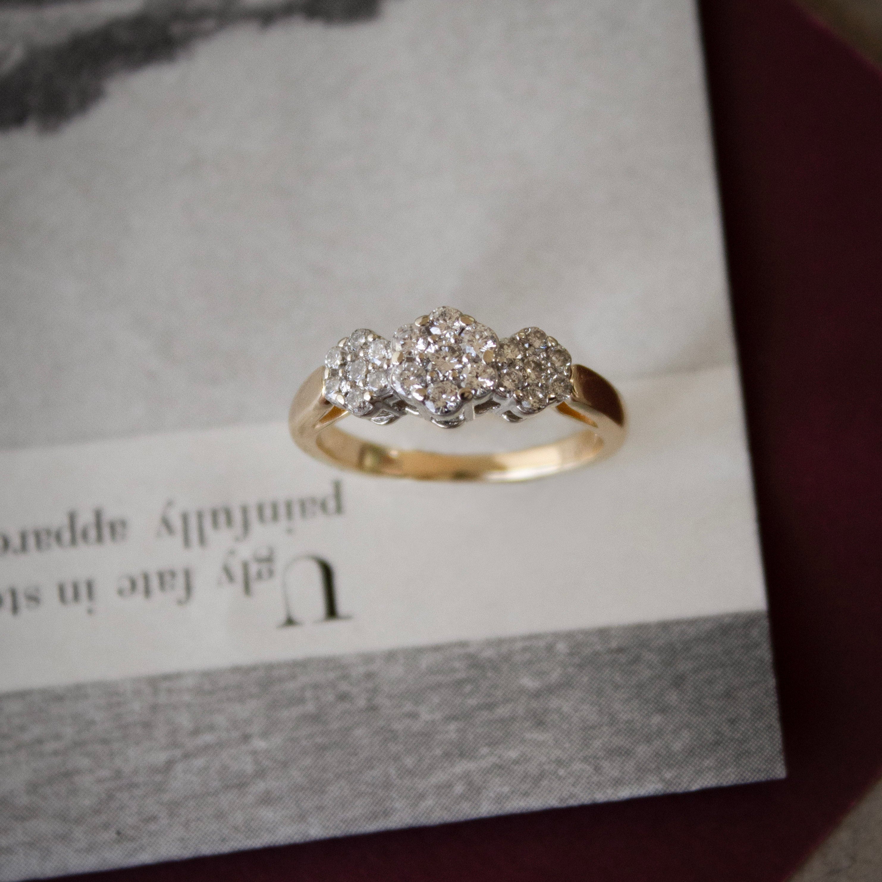 Gold ring with diamonds on a textured surface