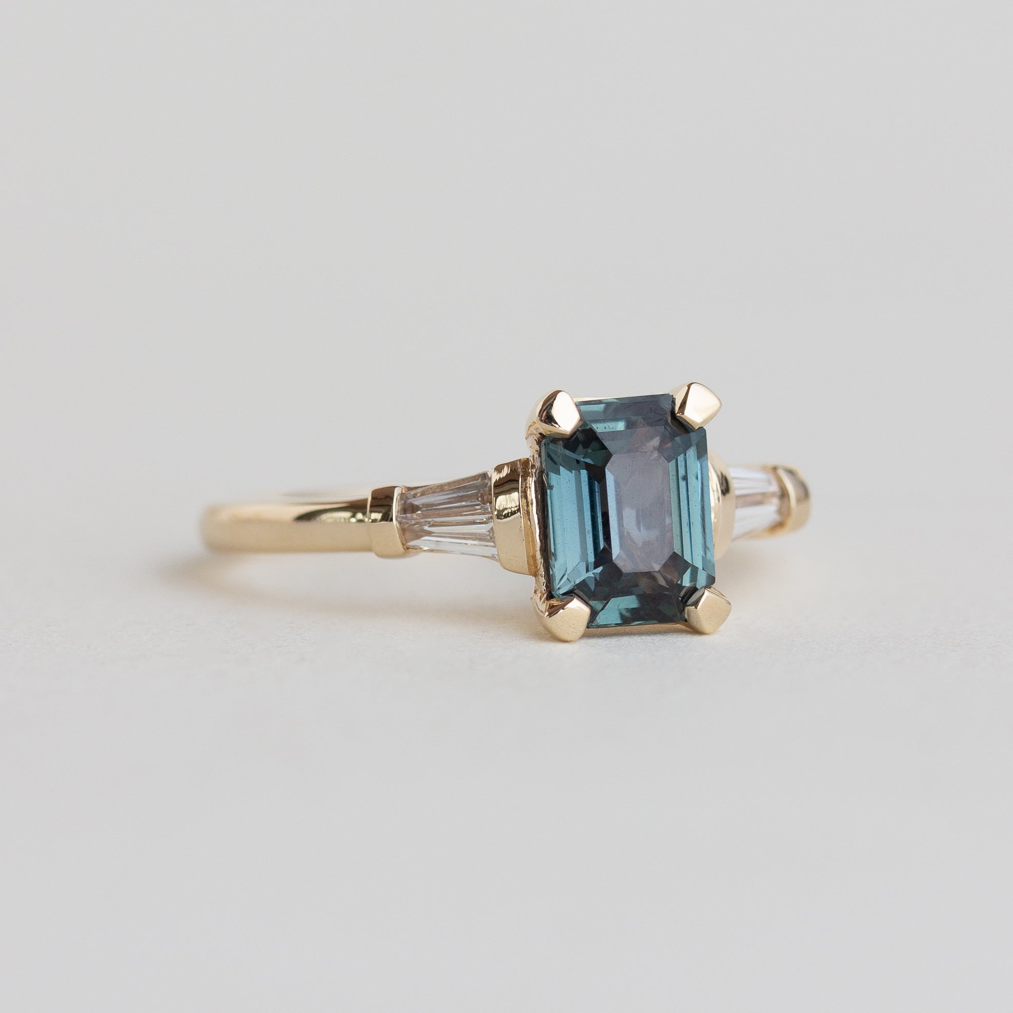 14k gold Art Deco style ring with teal sapphire and baguette diamonds