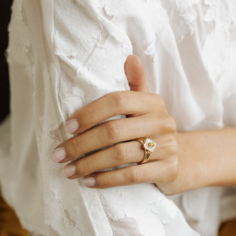 frances wedding band paired with engagement ring on models hand